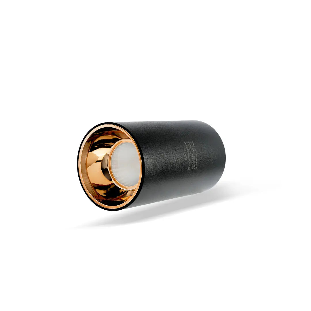 Black cylindrical object with gold interior on a white background